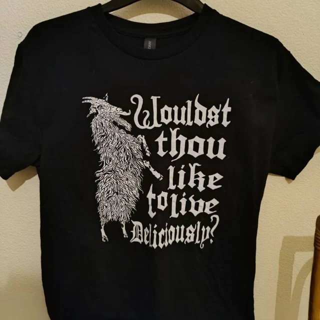 Black t-shirt with white graphic and text on a beige background